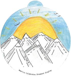 ornament depicting a sun rising over snow-capped mountains
