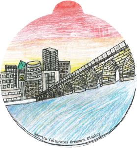 Ornament depicting a bridge over water stretching towards a city skyline