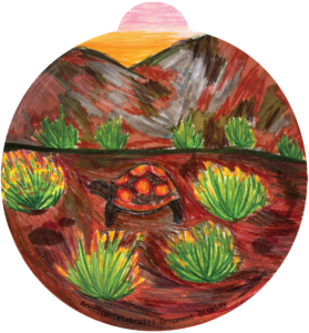 ornament depicting a turtle walking along bunches of cacti in a desert