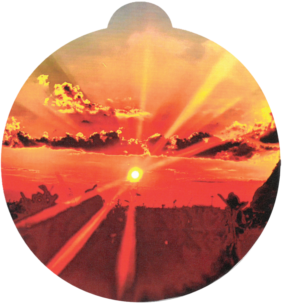 ornament depicting a sunrise over a field