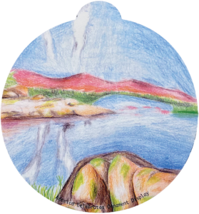 ornament depicting a body of water surrounded by technicolor mountains