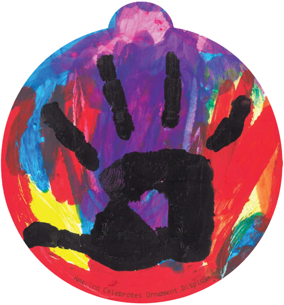 ornament with a collage of colors, on top a black handprint from a child