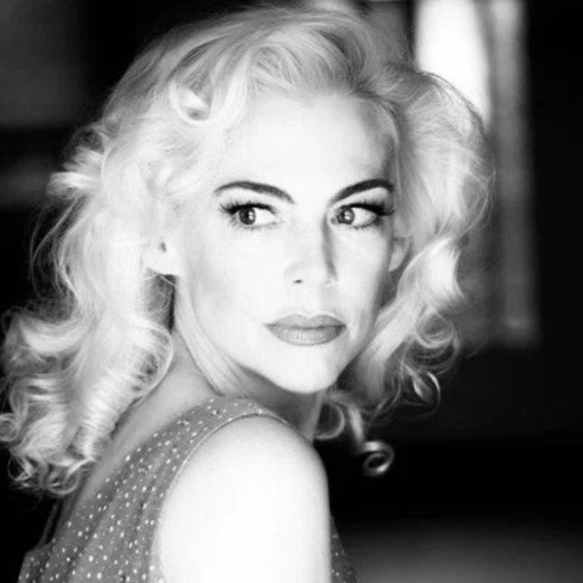 Image of Brenna Whitaker in black and white photo as she sits to the side.